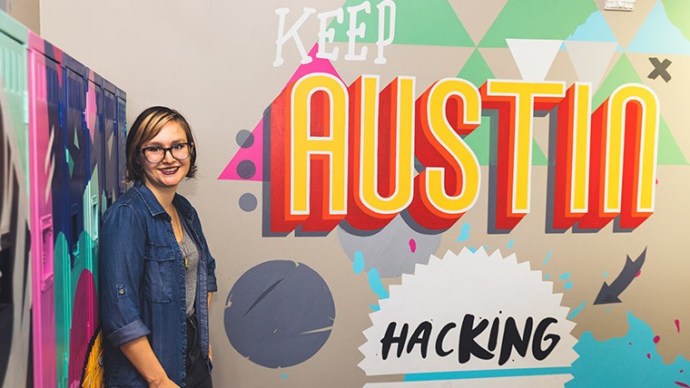 Irma Kramer with "Keep Austin Hacking" sign