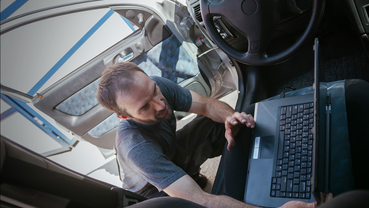 Man working on computer in truck