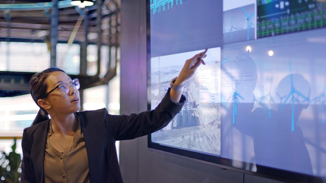 woman pointing at monitors for solutions