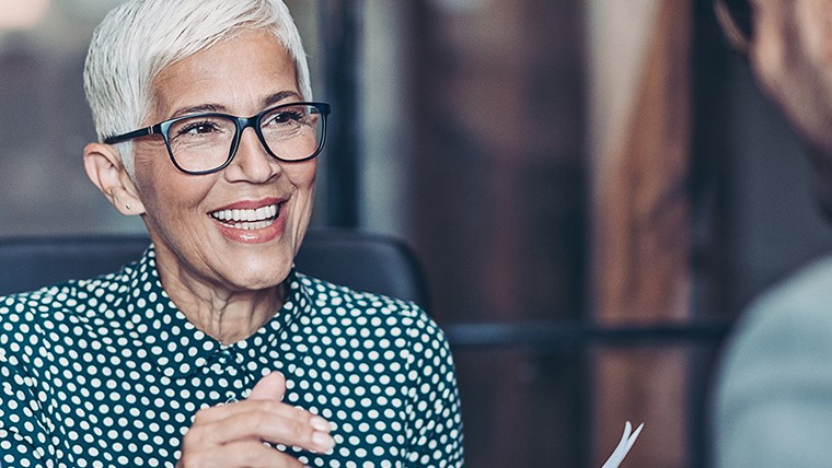 older woman wearing glasses smiling