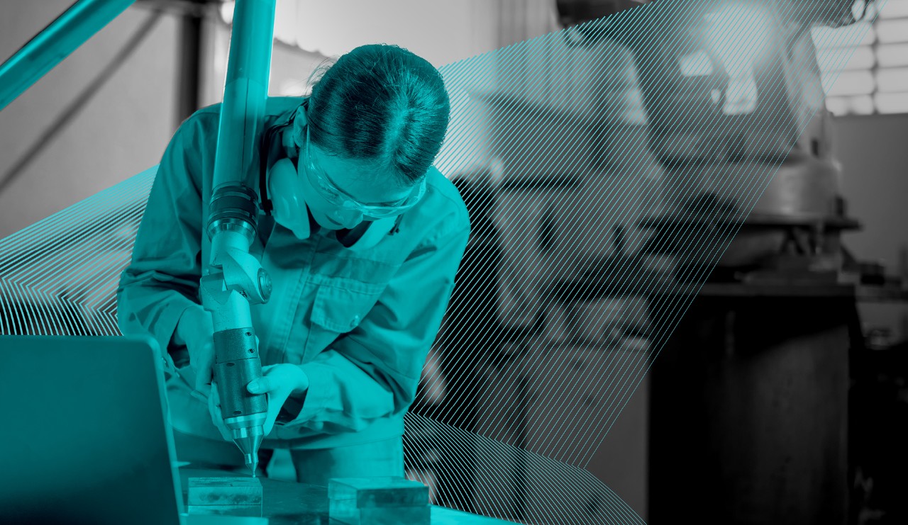 woman working at a machine with safety glasses