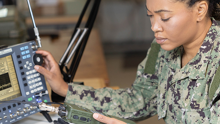 An African American woman in the military manages radio