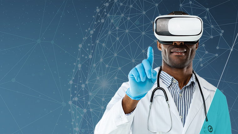 Male healthcare professional wearing virtual reality goggles, holding his finger up.