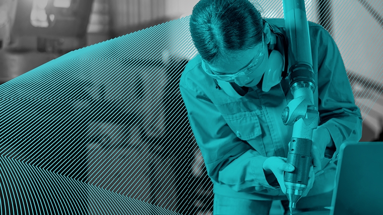woman working at a  machine wearing safety glasses