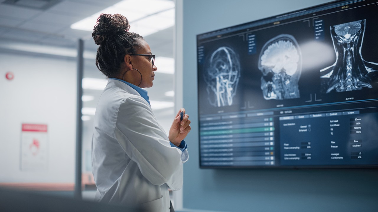 Female doctor looks at a screen