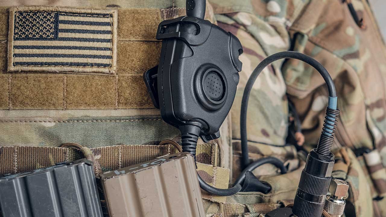Black Army soldier speaks on headset in Operations Room