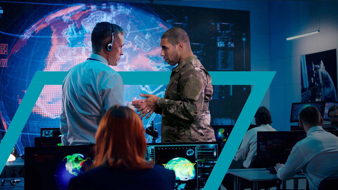 Army personnel speaking with an operator in a command center